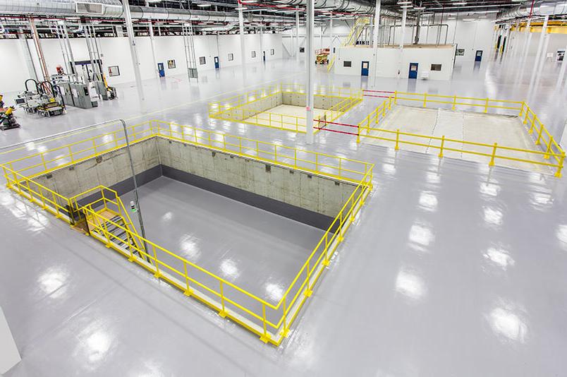 Interior of SAFRAN Aerospace Composite Facility. Large open white room with bright lights.